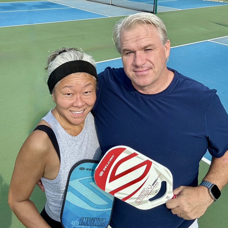 Trina and Mike on court with their paddles